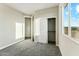 Bedroom featuring carpeted floors, a closet, and a view of the outdoors at 24959 S 190Th Dr, Buckeye, AZ 85326