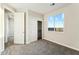 Bright bedroom features a closet, neutral carpet, and a large window with a clear view at 24959 S 190Th Dr, Buckeye, AZ 85326