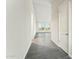 Hallway boasting hardwood floors and white walls and trim, leading into a bright, window-filled room at 24959 S 190Th Dr, Buckeye, AZ 85326