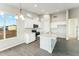 Bright kitchen featuring a quartz island, stainless appliances, and wood-look tile flooring at 24959 S 190Th Dr, Buckeye, AZ 85326