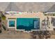 Aerial view of an in-ground pool with a spa and stone patio seating at 26231 W Maple Dr, Buckeye, AZ 85396