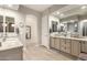 Elegant bathroom with double vanities, granite countertops, and stylish mirrors at 26231 W Maple Dr, Buckeye, AZ 85396