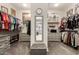 Spacious walk-in closet with dual hanging rods, shelving, drawers and a mirrored dressing area at 26231 W Maple Dr, Buckeye, AZ 85396