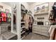 Well-organized closet featuring shoe storage, custom shelving, hanging rods, and a central vanity at 26231 W Maple Dr, Buckeye, AZ 85396