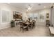 Well-lit dining room features a large window and a stylish, modern table set for eight at 26231 W Maple Dr, Buckeye, AZ 85396