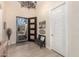 Inviting entryway with decorative chandelier, bench, and a view of the open front door at 26231 W Maple Dr, Buckeye, AZ 85396