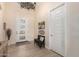 Inviting entryway with decorative chandelier, bench, and a view of the attractive front door at 26231 W Maple Dr, Buckeye, AZ 85396