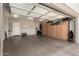 Well-organized garage featuring epoxy floors, custom cabinets, and plenty of room for vehicles and storage at 26231 W Maple Dr, Buckeye, AZ 85396