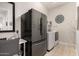 Modern laundry room with new appliances, adjacent office space, and ample storage at 26231 W Maple Dr, Buckeye, AZ 85396