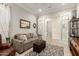 Comfortable living room featuring neutral tones, cozy seating, stylish decor, and adjacent bathroom access at 26231 W Maple Dr, Buckeye, AZ 85396