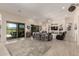 Spacious living room featuring sliding doors to the backyard and custom shelving at 26231 W Maple Dr, Buckeye, AZ 85396