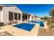 Inviting backyard pool and spa featuring stone surround and lush desert landscaping at 26231 W Maple Dr, Buckeye, AZ 85396