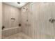 Neutral bathroom features a zero entry shower with a built in bench and multiple shower heads at 26231 W Maple Dr, Buckeye, AZ 85396