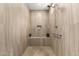 Modern walk-in shower featuring tiled walls, a built-in niche, and convenient grab bar at 26231 W Maple Dr, Buckeye, AZ 85396