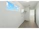 Bright laundry area features wood-look tile flooring, washer/dryer hookups, and a small window for natural light at 2744 S 357Th Dr, Tonopah, AZ 85354