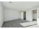 Sunlit main bedroom features plush carpet, closet, and a barn door leading to the en-suite bathroom at 2744 S 357Th Dr, Tonopah, AZ 85354