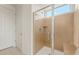 Bathroom featuring frameless glass shower with tiled walls and a bench at 26905 W Mcrae Dr, Buckeye, AZ 85396