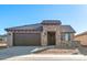 Beautiful single-story home featuring a stone facade, tile roof, and attached two-car garage at 26905 W Mcrae Dr, Buckeye, AZ 85396