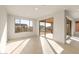 Sun-filled living room featuring tile floors, expansive windows and sliding glass doors with backyard views at 26905 W Mcrae Dr, Buckeye, AZ 85396