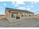 A single story tan home with a covered patio and multiple windows facing the backyard at 2762 S 357Th Dr, Tonopah, AZ 85354