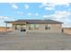 A single story tan home featuring a covered patio and multiple windows at 2762 S 357Th Dr, Tonopah, AZ 85354