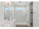 Spa-like bathroom featuring a glass-enclosed shower and modern vanity with sleek fixtures at 2762 S 357Th Dr, Tonopah, AZ 85354