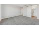 Spacious bedroom featuring neutral carpeting and a sliding barn door to the en-suite bathroom at 2762 S 357Th Dr, Tonopah, AZ 85354