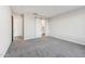 Large bedroom with sliding barn door entrance to bath, carpet flooring, and ample natural light at 2762 S 357Th Dr, Tonopah, AZ 85354