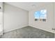 Bright bedroom with neutral walls, plush carpet, and a window offering an open view at 2762 S 357Th Dr, Tonopah, AZ 85354