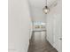 A long hallway showcasing wood-look flooring and a decorative light fixture at 2762 S 357Th Dr, Tonopah, AZ 85354