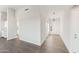 A long hallway featuring wood-look flooring and an entrance with an orb pendant light at 2762 S 357Th Dr, Tonopah, AZ 85354