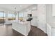 A kitchen island featuring quartz countertops, white cabinets, and stainless steel appliances at 2762 S 357Th Dr, Tonopah, AZ 85354