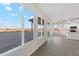 Open living space boasting wood-look floors, light walls, a kitchen island and backyard views at 2762 S 357Th Dr, Tonopah, AZ 85354