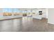 Open concept living space featuring wood-look floors, light walls, and ample windows at 2762 S 357Th Dr, Tonopah, AZ 85354