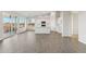 Open living space with wood-look floors, light walls, an island and ample windows at 2762 S 357Th Dr, Tonopah, AZ 85354