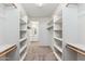 Spacious walk-in closet with lots of shelving, rod and carpet flooring at 2762 S 357Th Dr, Tonopah, AZ 85354