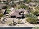 Stunning aerial view of a desert home featuring a red tile roof, lush landscaping, and a private backyard at 27728 N 68Th Pl, Scottsdale, AZ 85266