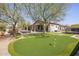 Estate home features a backyard putting green and mature landscaping at 27728 N 68Th Pl, Scottsdale, AZ 85266