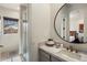 Well-lit bathroom featuring marble countertop, shower, and modern design at 27728 N 68Th Pl, Scottsdale, AZ 85266