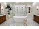 Luxurious bathroom with freestanding tub, dual shower heads and marble tile floor at 27728 N 68Th Pl, Scottsdale, AZ 85266