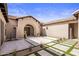 Stunning home exterior boasts a courtyard with decorative pavers, plants, and string lights at 27728 N 68Th Pl, Scottsdale, AZ 85266