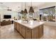 Open kitchen with an oversized island, pendant lighting, and a view of the outdoor landscape at 27728 N 68Th Pl, Scottsdale, AZ 85266