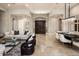 Spacious living room featuring travertine floors, modern decor, and an elegant dining area at 27728 N 68Th Pl, Scottsdale, AZ 85266