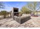 Outdoor living area features a fireplace, TV, and comfortable seating at 27728 N 68Th Pl, Scottsdale, AZ 85266