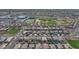 Aerial view showcasing a residential area with a football field, baseball fields, and rows of single-Gathering homes at 2983 E Harrison St, Gilbert, AZ 85295