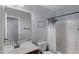 Clean bathroom featuring a shower with white tiling, a white sink, and light gray walls at 2983 E Harrison St, Gilbert, AZ 85295