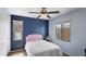 Cozy bedroom with blue accent wall, ceiling fan and a pink headboard providing a calming space at 2983 E Harrison St, Gilbert, AZ 85295