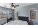 Well-lit bedroom featuring a dark gray padded headboard, desk, and dual windows, offering a bright and functional space at 2983 E Harrison St, Gilbert, AZ 85295