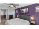 Cozy bedroom with a king-size bed, ceiling fan, and a cityscape photograph at 2983 E Harrison St, Gilbert, AZ 85295