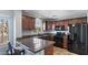 Well-lit kitchen featuring granite countertops, wooden cabinets, and modern black appliances at 2983 E Harrison St, Gilbert, AZ 85295